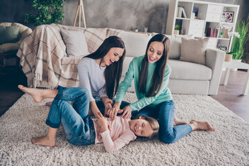 Portrait of attractive funny funky cheerful family resting having fun tickling spending weekend...