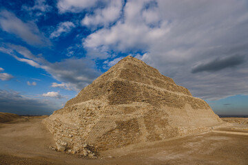 Majestic View to the Step Pyramid of Djoser under blue sky, is an archaeological site in the Saqqara necropolis, northwest of the city of Memphis, Egypt