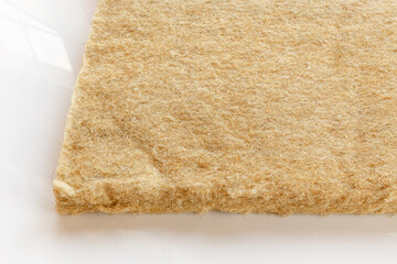 materials background - compressed thermal insulating hemp fiber bonded panels.