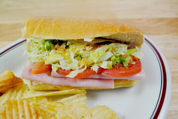 A Sub Sandwich with Potato Chips Served as a Cold Lunch	