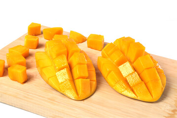 Southeast Asian fruit, fresh hedgehog style Mango preparation, cubes and chunks on wooden cutting...