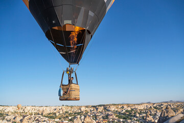 hot air balloon flies low over cities