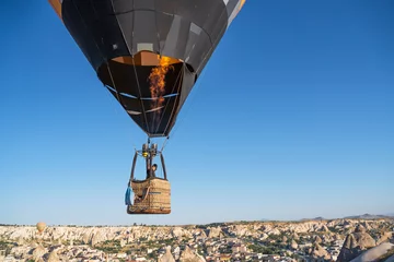 Poster hot air balloon flies low over cities © Sergey