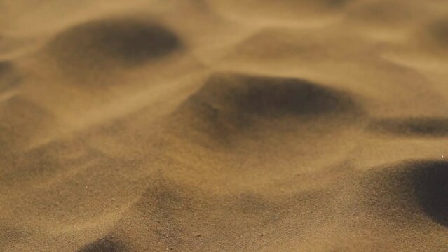 Slow motion closeup shot of sand dust of sand dunes flowing in the air at Sam sand dunes in Thar desert at Jaisalmer in Rajasthan, India. Sand particles flowing in the air due to the wind in desert. 