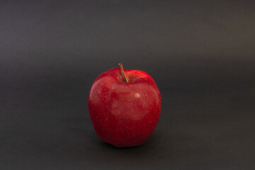 A red apple on a black background