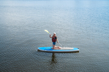 pretty slim woman relax on sup board in summer time, sea adventure