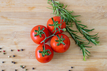 tomatoes with greens on wooden bottom