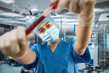 nurse in hospital holding blood in test tubes for analysis