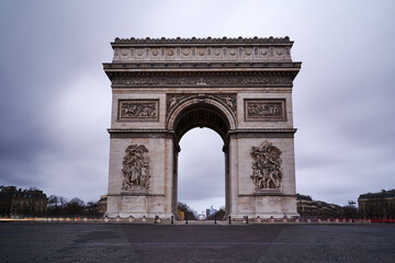 Beautiful shot of the Arc de Triomphe against a cloudy gray sky in Paris, France