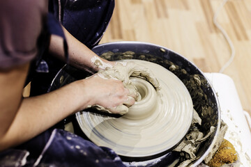 Woman Pottery Artist. Molding Clay On Pottery Wheel At Art Workshop . Ceramic Studio. Closeup View. Female Hands Shapes Clay.	