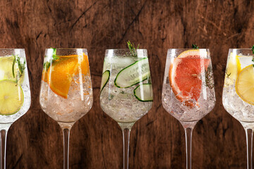 Gin and tonic cocktails set. Alcoholic drinks with lime, lemon, grapefruit, cucumber, soda and...