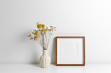 Square frame mockup over white wall with copy space for artwork, photo or print presentation