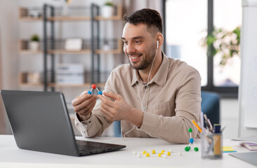 distant education, school and remote job concept - happy smiling male chemistry teacher with laptop...
