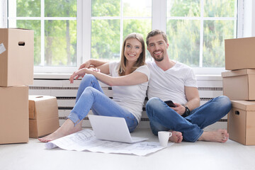 Young happy family moving into their new home