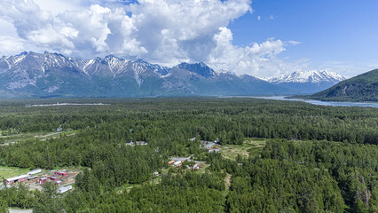 Aerial view of a summer day over the rural area near mountains in Palmer, Alaska - obrazy, fototapety, plakaty