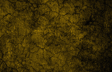 Cracked old dark yellow concrete wall with abstract grunge texture