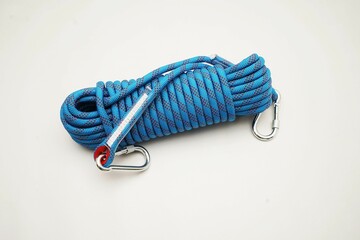 Blue climbing rope on white background