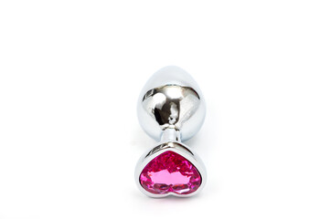 Metal butt plug with a decorative pink heart-shaped stone at the end.