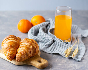 two croissants lie on a dark gray plate, the minimalism of a healthy breakfast