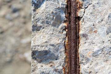 Old reinforced concrete structure with damaged and rusty metallic reinforcement that must be...