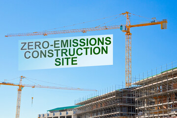 Zero-Emissions and Carbon Neutrality in building activity and construction industry - concept with text and tower crane in a construction site - obrazy, fototapety, plakaty