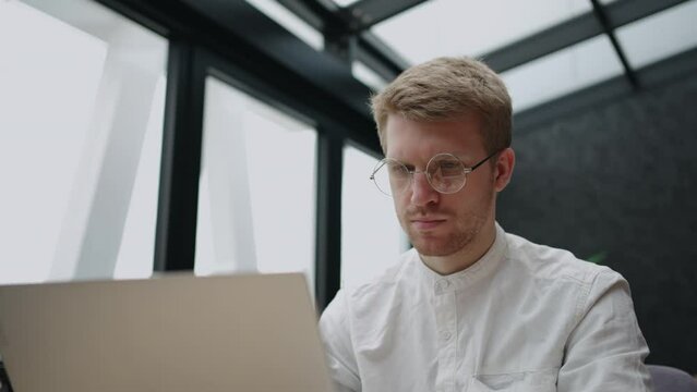 customer service department in it-company, adult man is typing message in online chat for answer