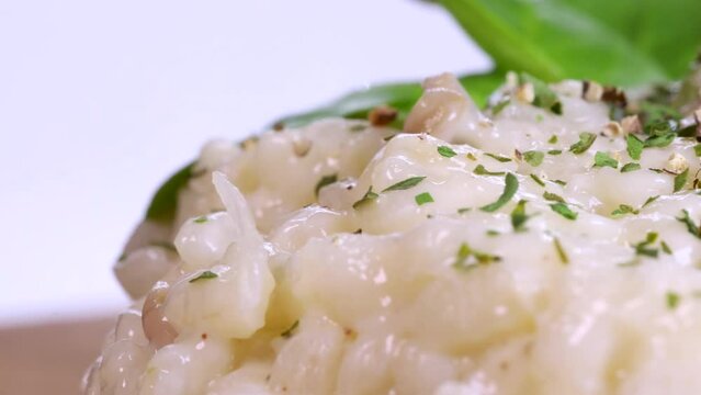 Macro shot of homemade risotto rotating, close up view in 4k. Beautiful dish.