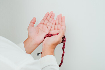 Close up Hand holding a tasbih or prayer beads