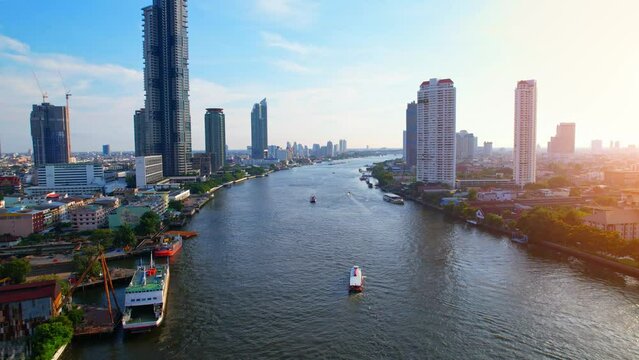 Aerial view over Bangkok city and Chao phraya river. Lots of high rise buildings in the economic district in Bangkok, Thailand. Drone 4K shot.
