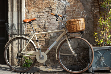 Vintage bicycle with basket resting on the streets of Rome in the Trastevere