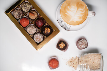Box of homemade sweets on white background. Several sweet candies on white table.