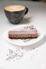 Cake on a white plate decorated with lavender.