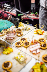 Chef hand is in process of Preparing catering food on table