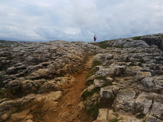 Girl on the top of a rocky hill