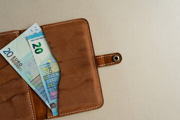 Money in the dockholder. Two banknotes of 20 euros in a wallet.