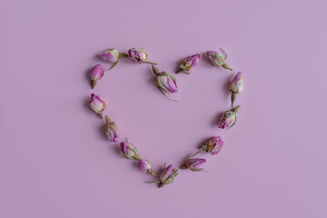 Heart of flowers on a pink background.