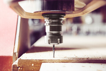 CNC milling machine. Machine tool in wood factory with drilling machines.