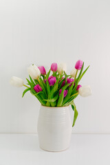 Bouquet of purple and white tulips on a white background