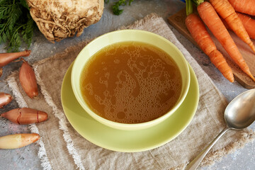 A bowl of beef bone broth on a table