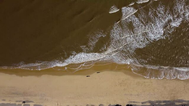 4k drone footage of waves breaking on a beach in Suffolk, UK