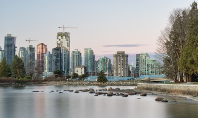 Panoramic View of Modern City Building Skyline on West Coast Pacific Ocean. Sunny Winter Sunrise. Seawall at Stanley Park, Coal Harbour, Downtown Vancouver, British Columbia, Canada.