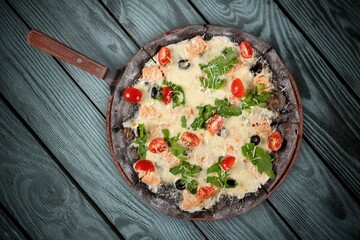 Tasty homemade pizza with fresh mozzarella and basil leaves.
