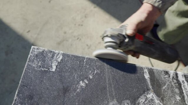 Grinding granite stone with a grinder.