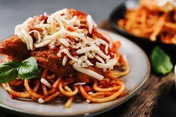 Homemade Chicken parmesan or parmigiana with cheese and sauce, selective focus