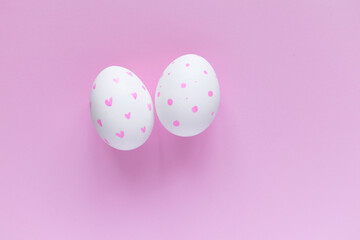 Easter layout. Decorated eggs against a pink background. Easter card. Decorate. Congratulate. Pink monochrome.
