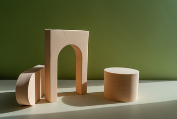 Interior still life with a geometric figure. Composition in a minimalist style. Beige elements on a green background.