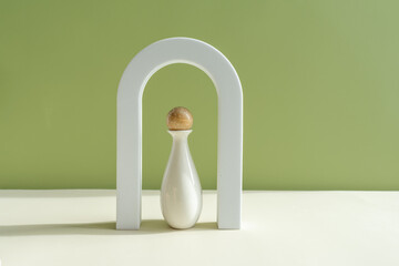 Interior still life with a geometric figure, shadows and sunlight. Composition in a minimalist style. Vase with decorative elements on a green background.