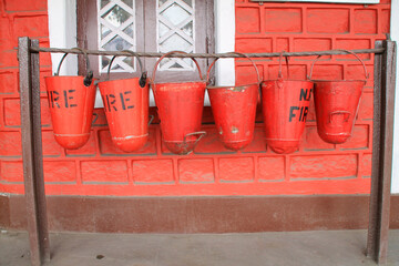 Closeup of vibrant red fire extinguishing buckets of sand in Darjeeling, India