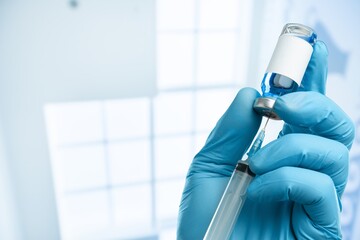 Injectable vaccine for the vaccination program of coronavirus Omicron. Doctor holds the syringe