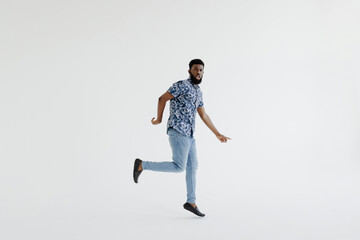 Fototapeta na wymiar I did it. Full length of handsome young black man jumping against white background